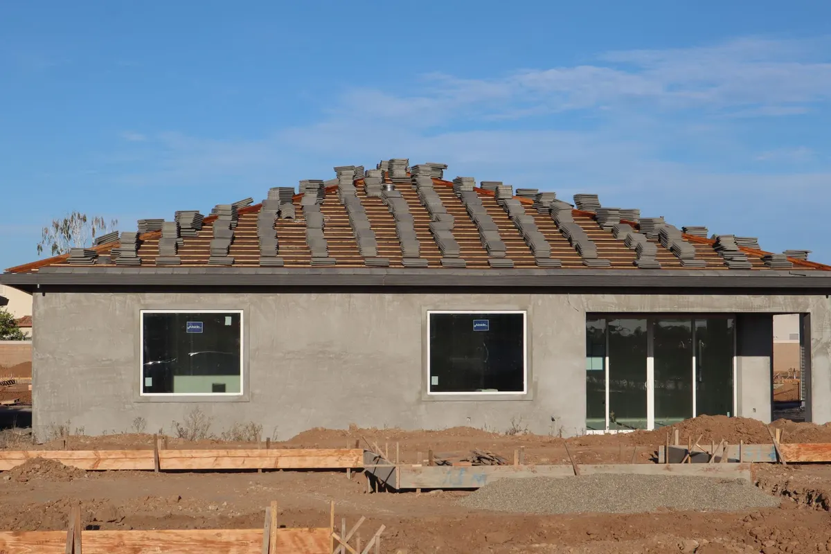 Newly built home with a tile roof awaiting final inspection