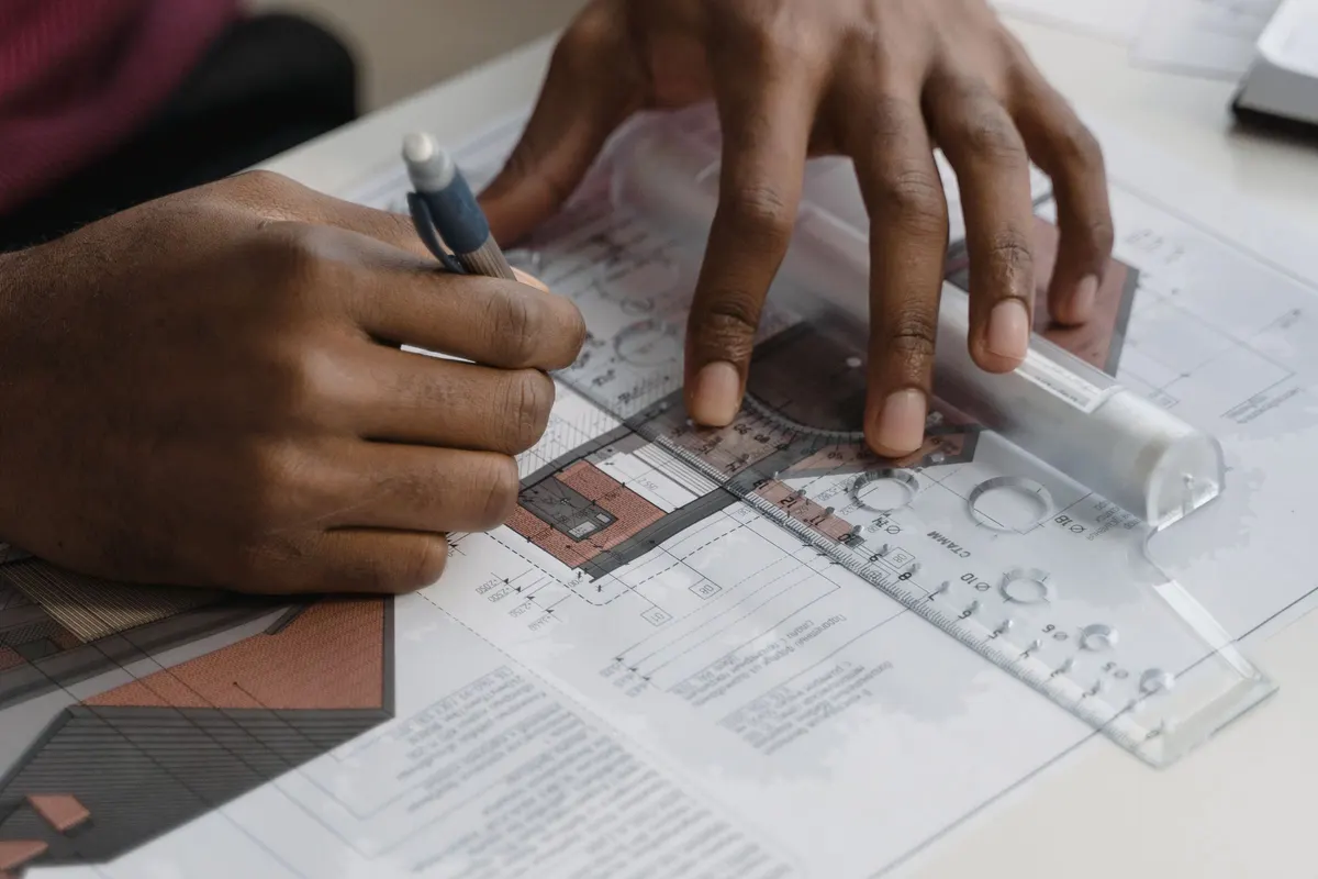 Architect drawing plans with a ruler and pencil